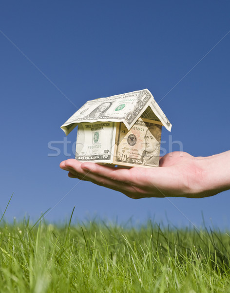 Man holding a dollar house outside Stock photo © gemenacom