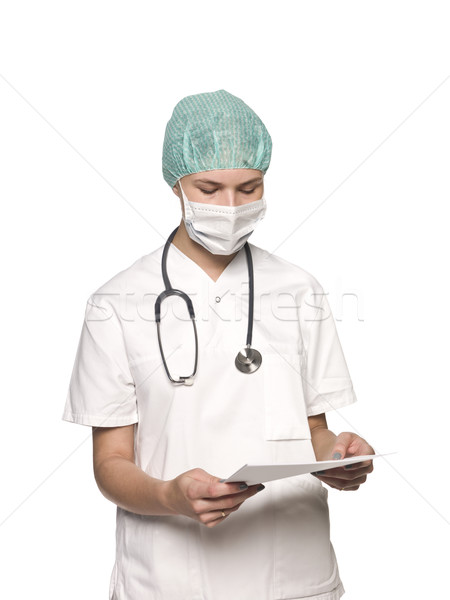 Nurse with stethoscope and a journal towards white background Stock photo © gemenacom