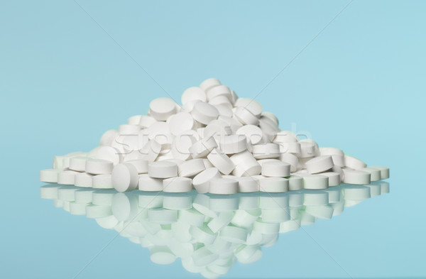 Stack of pills towards blue background Stock photo © gemenacom
