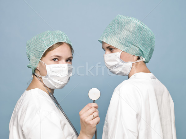 Two female nurses with sugical masks and a stethoscope Stock photo © gemenacom