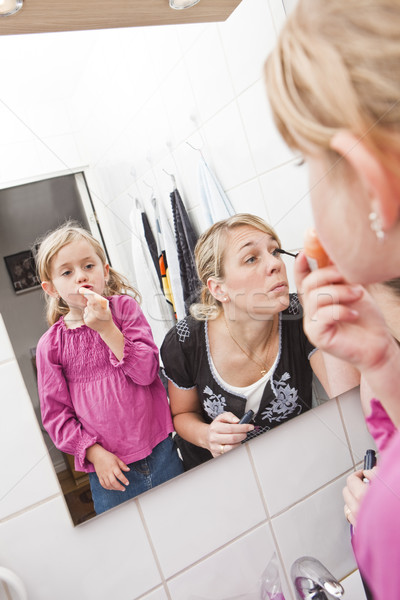 Mother and Daughter put on make-up Stock photo © gemenacom