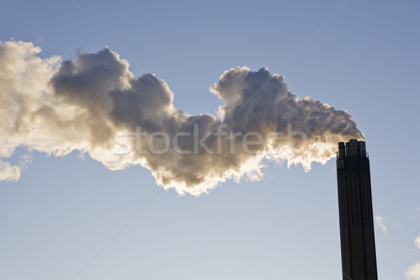 Smoking chimney against a blue sky Stock photo © gemenacom