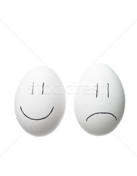 Stock photo: Sad face and a happy face painted on white eggs