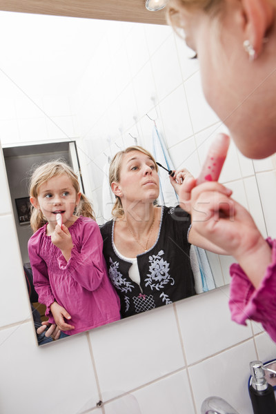 Mother and daughter put on make-up Stock photo © gemenacom