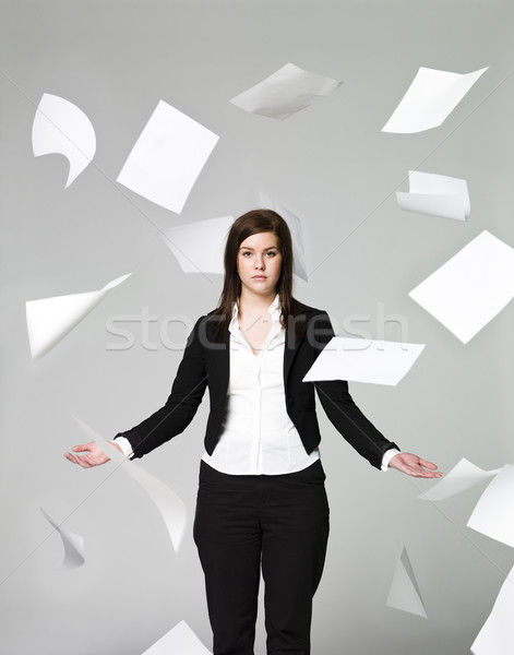 Office girl with a lots of papers flying around Stock photo © gemenacom