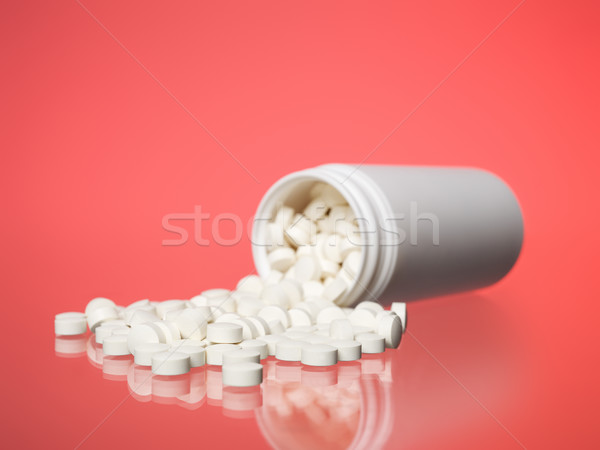 Can with pills towards red background Stock photo © gemenacom