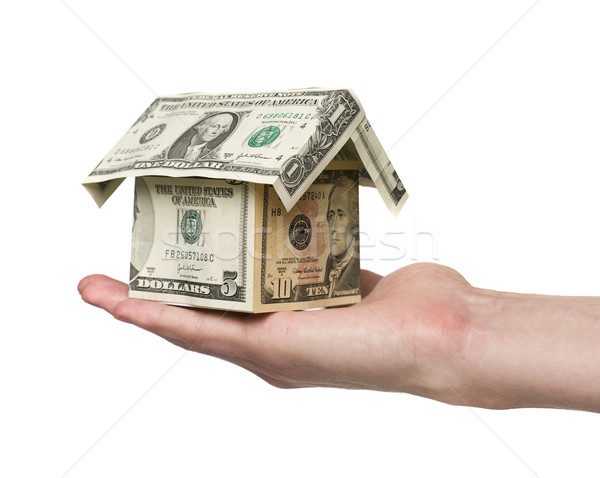 hand holding a small house built out of dollar bills Stock photo © gemenacom