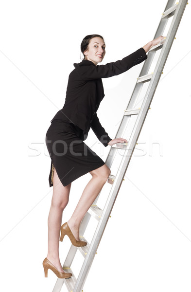 Stock photo: Smiling woman climbing up the ladder