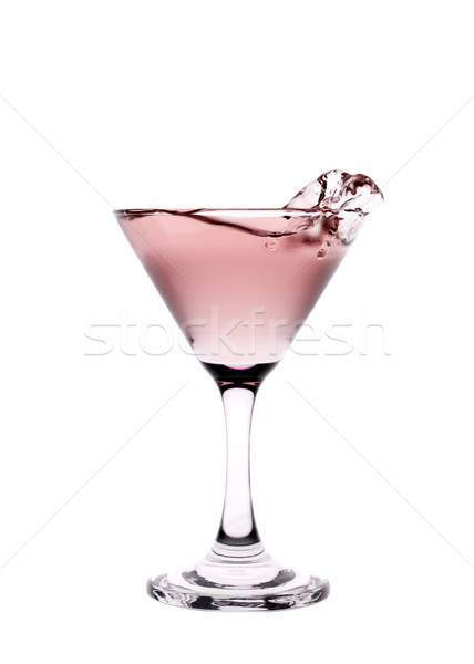 Red liquid splashing in a martini glass isolated on white backgr Stock photo © gemenacom