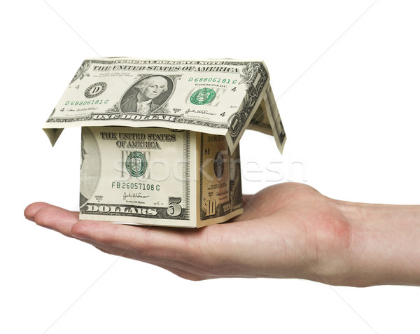 hand holding a small house built out of dollar bills Stock photo © gemenacom
