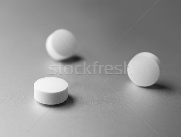 Three pills at silver background Stock photo © gemenacom