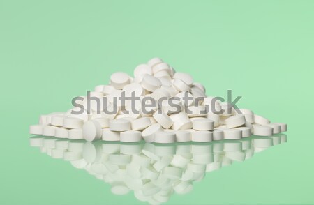 Stack of pills towards green background Stock photo © gemenacom