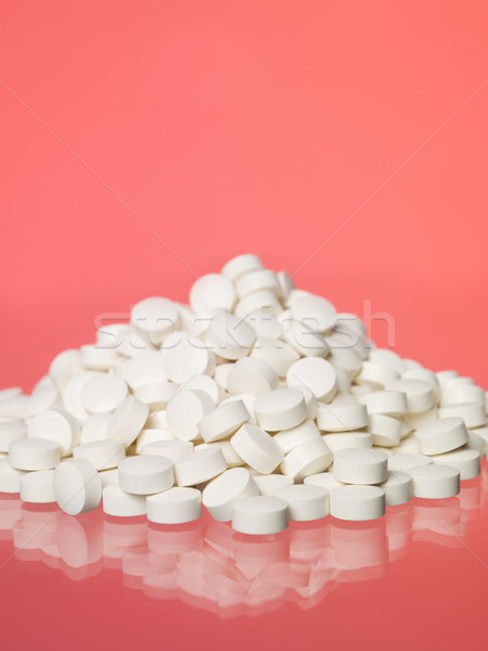 Stack of pills towards red background Stock photo © gemenacom