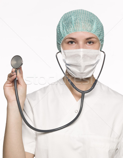 Female nurse with a stethoscope isolated towards white backgroun Stock photo © gemenacom
