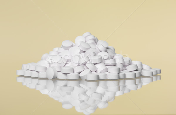 Stack of pills towards Yellow background Stock photo © gemenacom