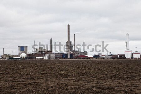 Industrial clădirilor in spatele câmp noros zi Imagine de stoc © gemenacom