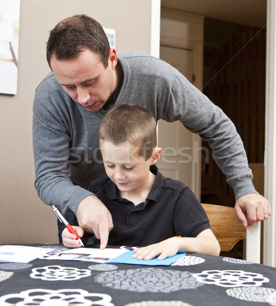 Father helping son with homework Stock photo © gemenacom