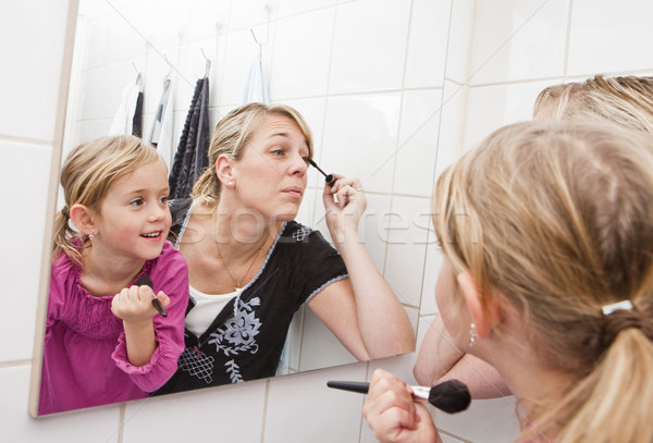 Mother and daughter put on make-up Stock photo © gemenacom