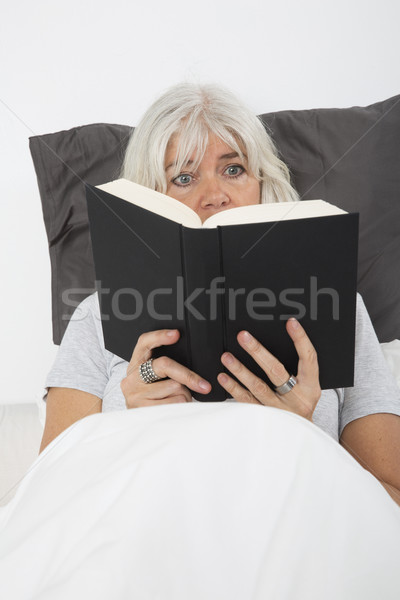 Woman Absorbed by the book Stock photo © gemenacom