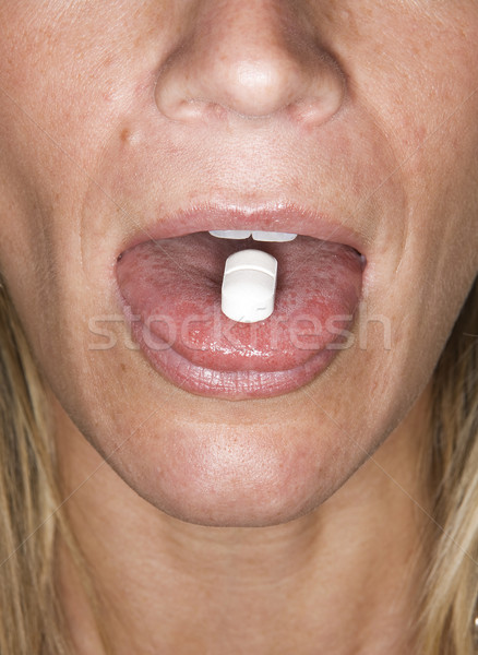Woman eating pill Stock photo © gemenacom