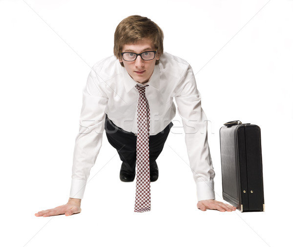 Stock photo: Buisnessman doing push-up's in a suit