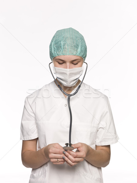 Nurse with a stethoscope isolated towards white background Stock photo © gemenacom