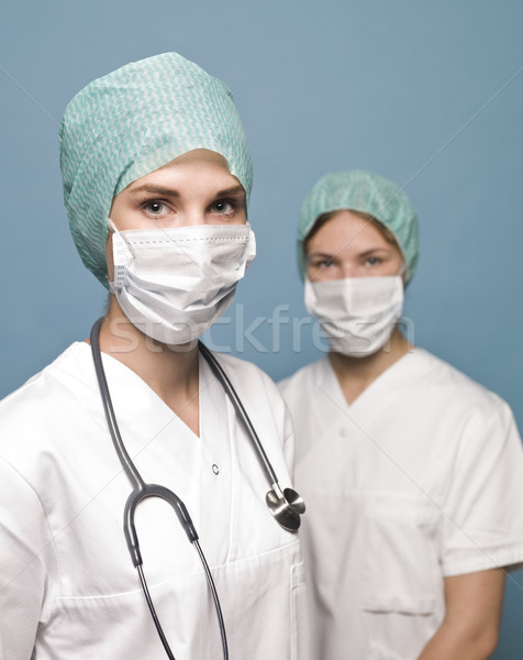 Two female nurses with surgical masks and a stethoscope Stock photo © gemenacom
