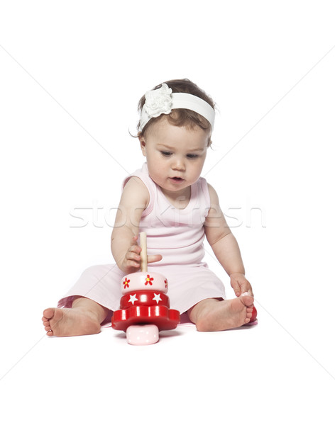 Baby in pink clothes playing with a red toy Stock photo © gemenacom