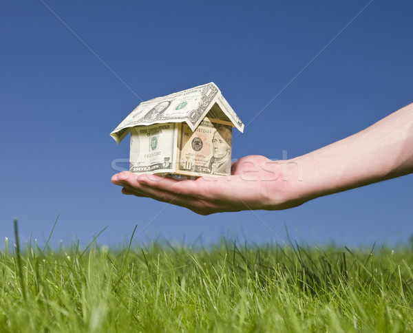 Man holding a dollar house outside Stock photo © gemenacom