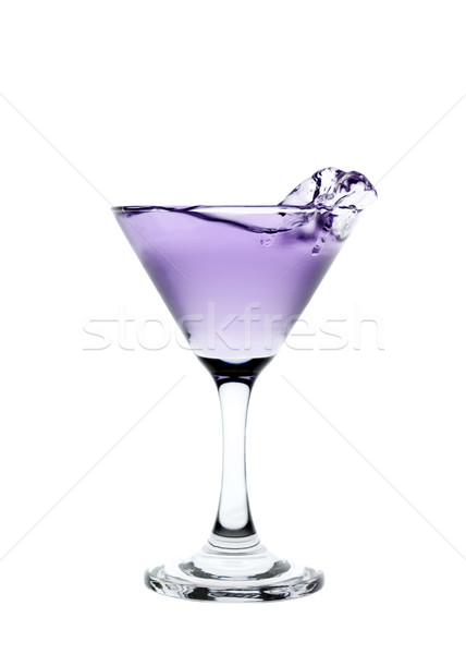 Purple liquid splashing in a martini glass isolated on white bac Stock photo © gemenacom