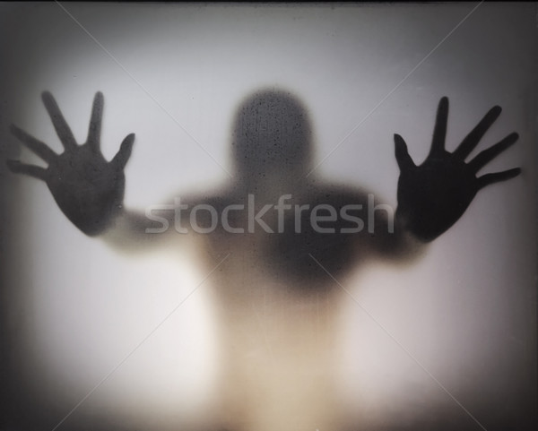 Man standing behind frosted glass Stock photo © GeniusKp