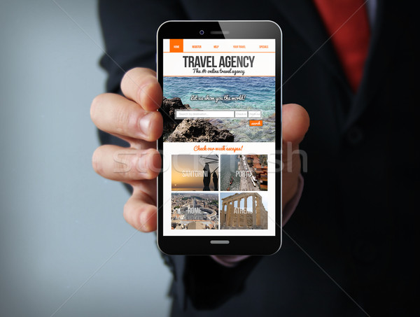 travel agency website on screen businessman smartphone Stock photo © georgejmclittle