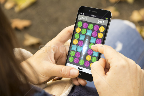 girl playing mobile game Stock photo © georgejmclittle