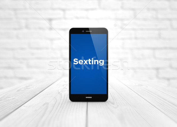 smart phone over wooden table sexting Stock photo © georgejmclittle