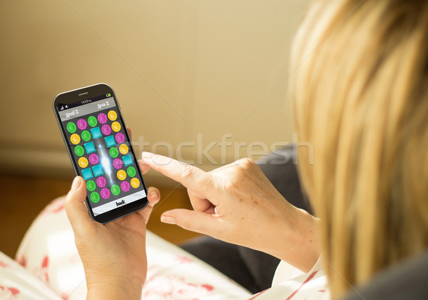 Technology woman gaming smartphone Stock photo © georgejmclittle