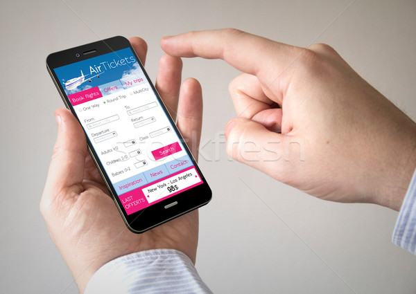 Ekran dotykowy smartphone bilet lotu aplikacja Zdjęcia stock © georgejmclittle