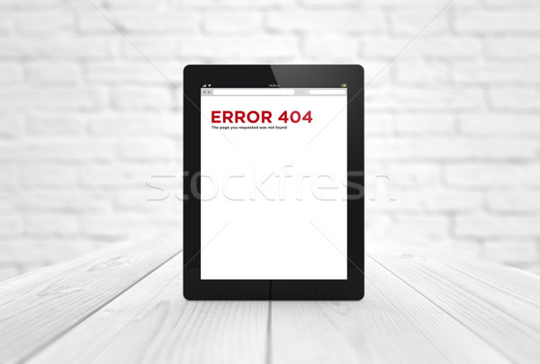 error 404 tablet on wooden table Stock photo © georgejmclittle