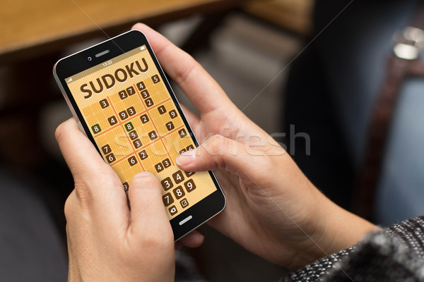 woman playing sudoku app Stock photo © georgejmclittle