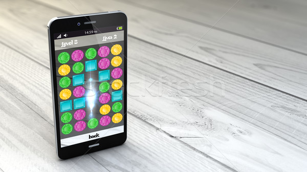 gaming smartphone over white wooden background Stock photo © georgejmclittle