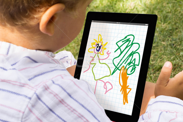 Boy drawing with tablet Stock photo © georgejmclittle