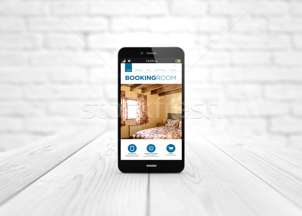 smart phone booking website over wooden table  Stock photo © georgejmclittle