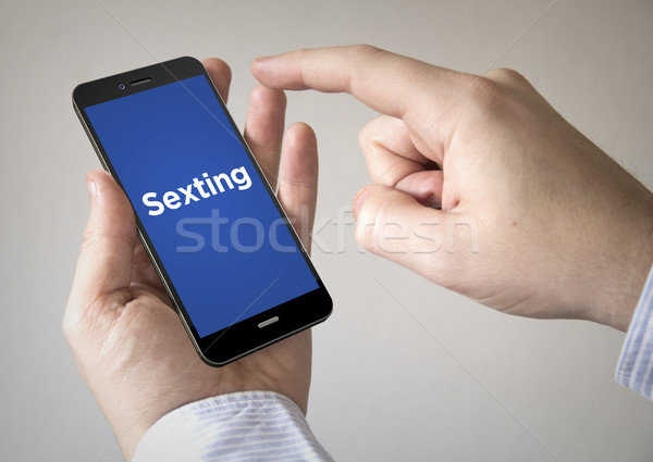  touchscreen smartphone with sexting on the screen Stock photo © georgejmclittle