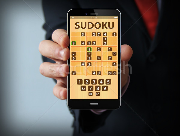 businessman with sudoku game on a smartphone Stock photo © georgejmclittle