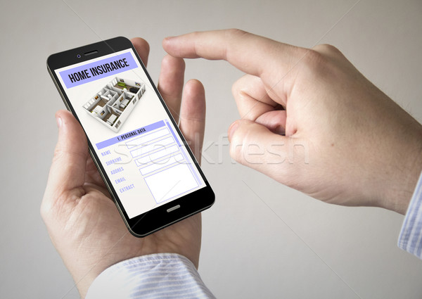  touchscreen smartphone with home insurance on the screen Stock photo © georgejmclittle