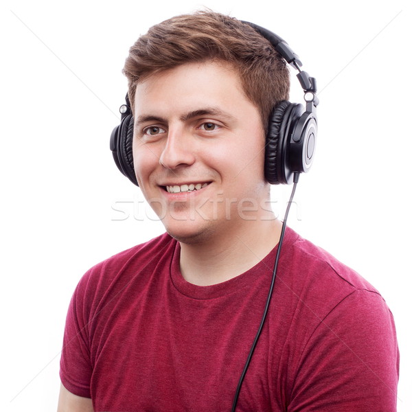Szczęśliwy młody człowiek młodych człowiek słuchania coś Zdjęcia stock © georgemuresan