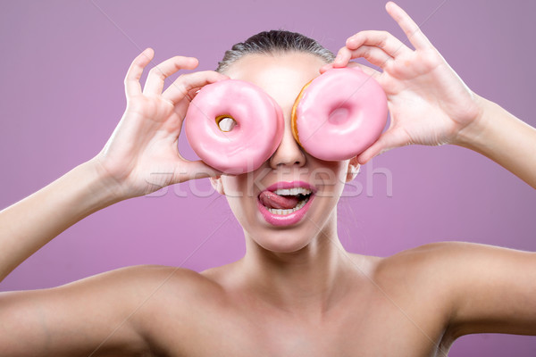 Beautiful woman with donuts, his two eyes are pink  donut Stock photo © Geribody