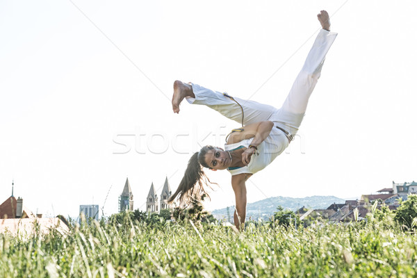 Capoeira woman, awesome stunts in the outdoors Stock photo © Geribody