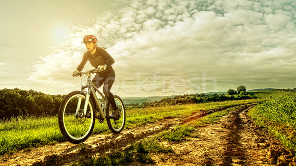 Sport bike woman on a meadow with a beautiful landscape Stock photo © Geribody