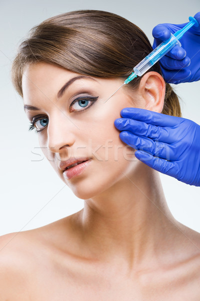 Plastic surgery - Beautiful woman's face with hypodermic needle  Stock photo © Geribody