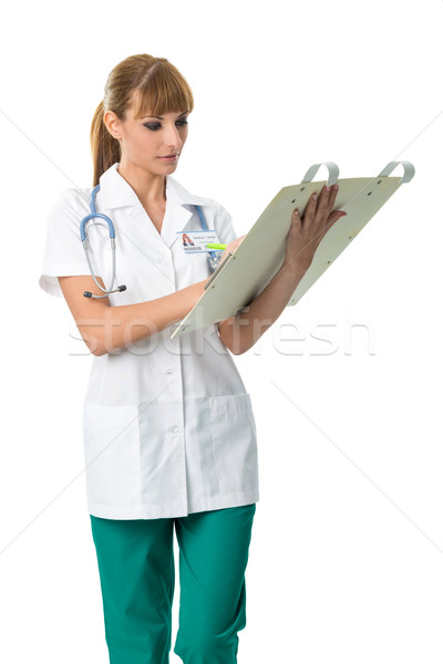 Smiling Doctor in white medical gown writing Stock photo © Geribody